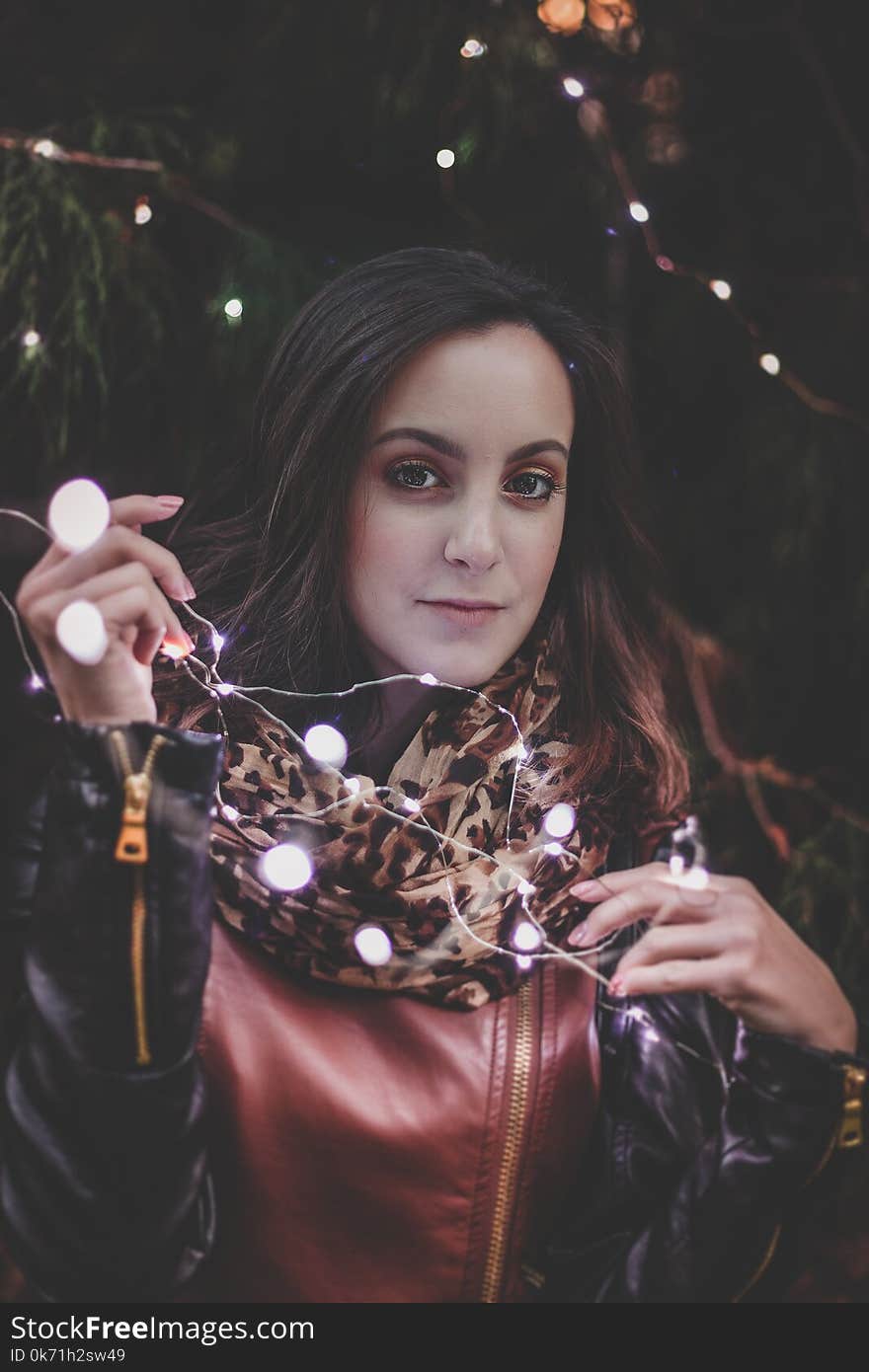 Woman Holding White String Lights