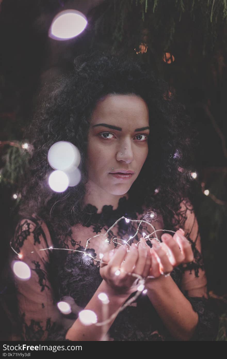 Woman Holding White String Lights