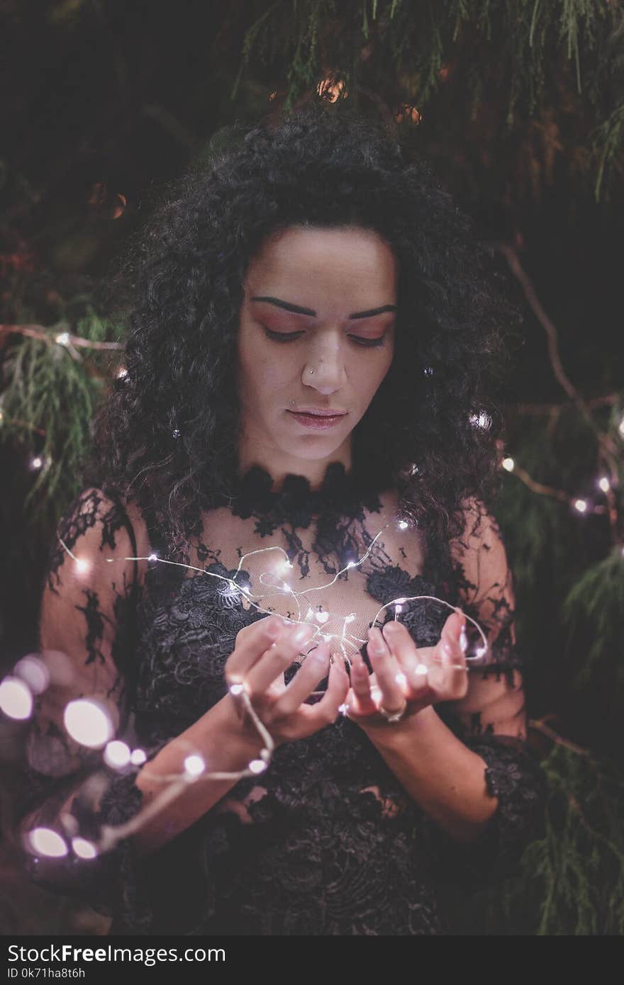 Woman Wearing Black Floral Dress Holding Fairy Light