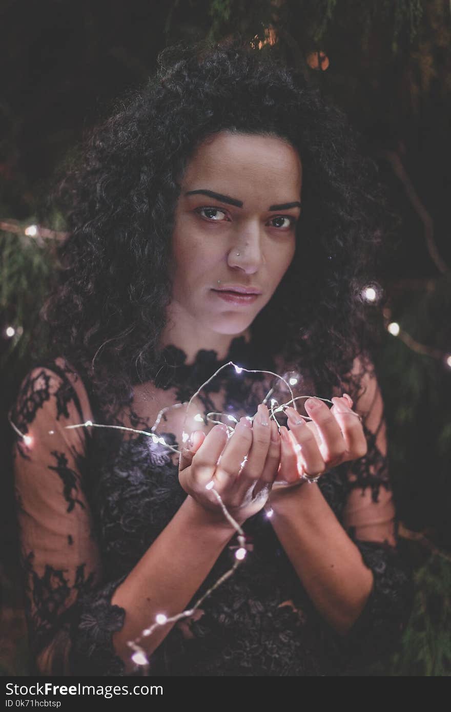 Woman In Black Lace Dress Holding String Lights