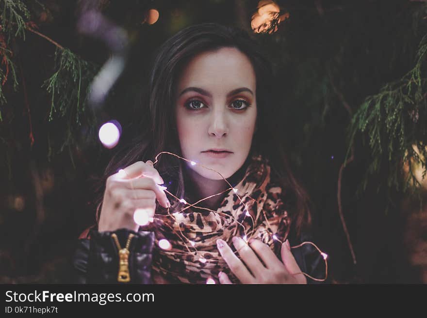 Woman Holding White String Lights