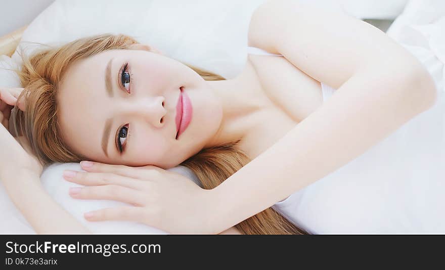 Woman wake up on bed in the morning