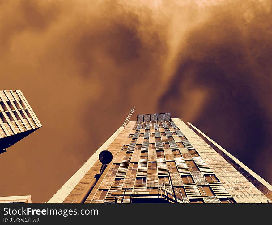 Low-angle Photography of Brown Concrete Building Under Brown Clouds