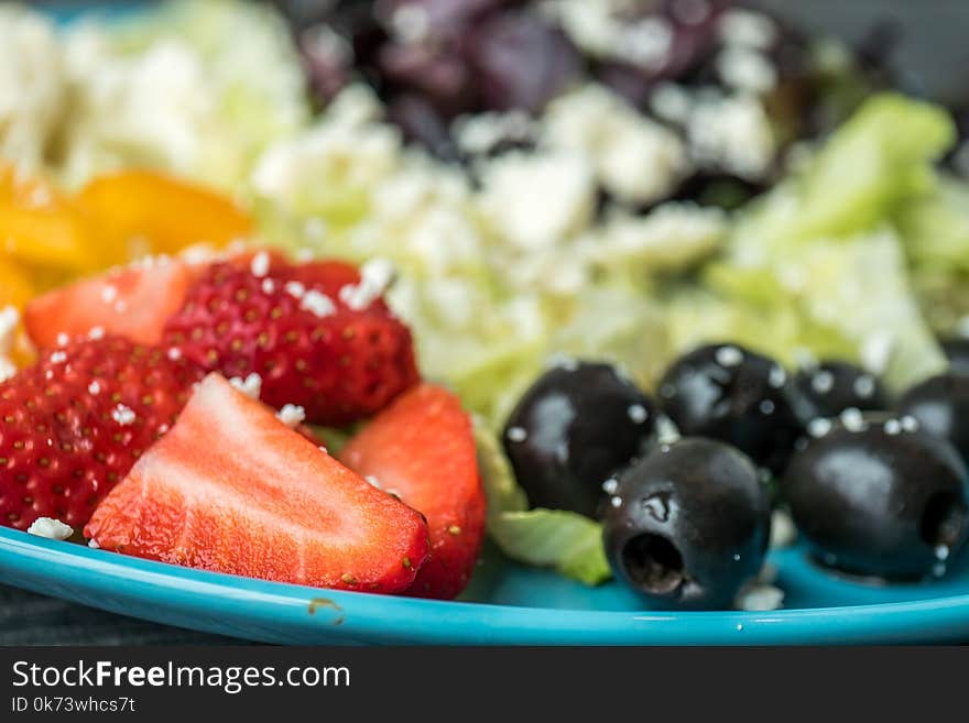 Shallow Focus Photography of Sliced Strawberries and Black Olives