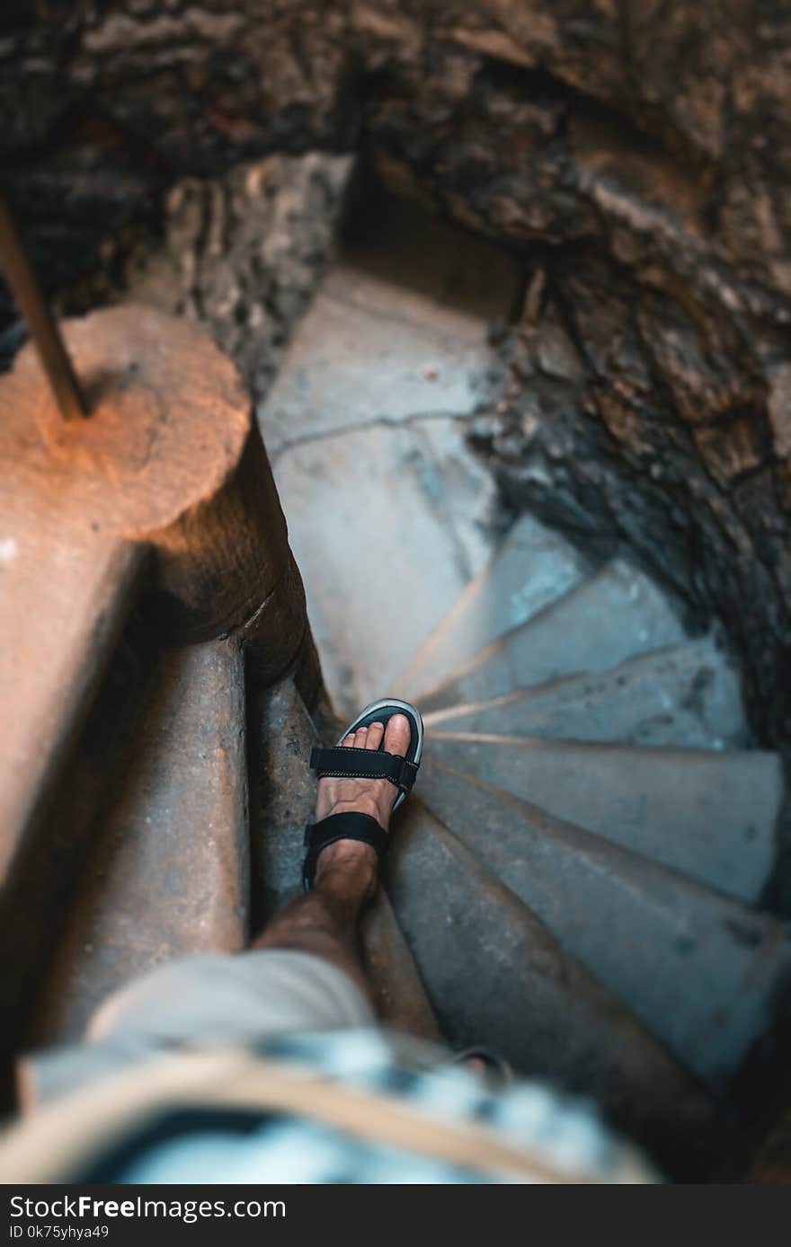 Man goes down the stairs, medieval castle.