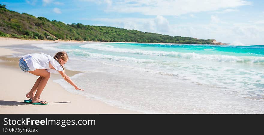 Adorable little girl on white tropial beach