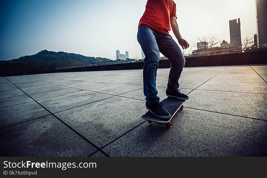 Skateboarder skateboarding at sunrise city