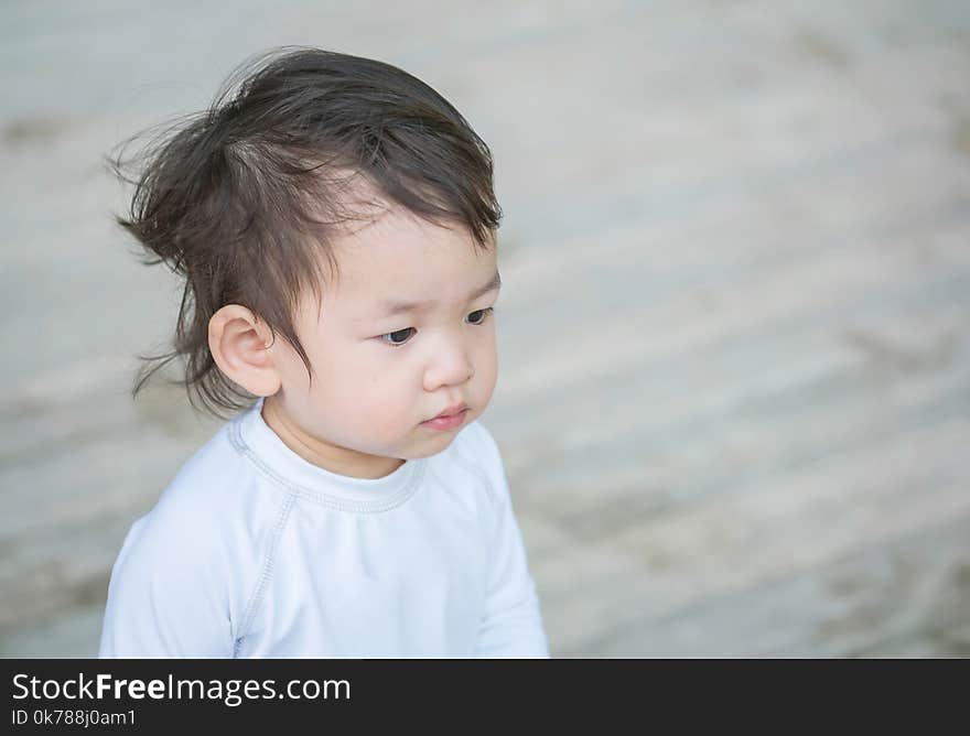 Closeup cute asian kid interest in something emotion with copy space