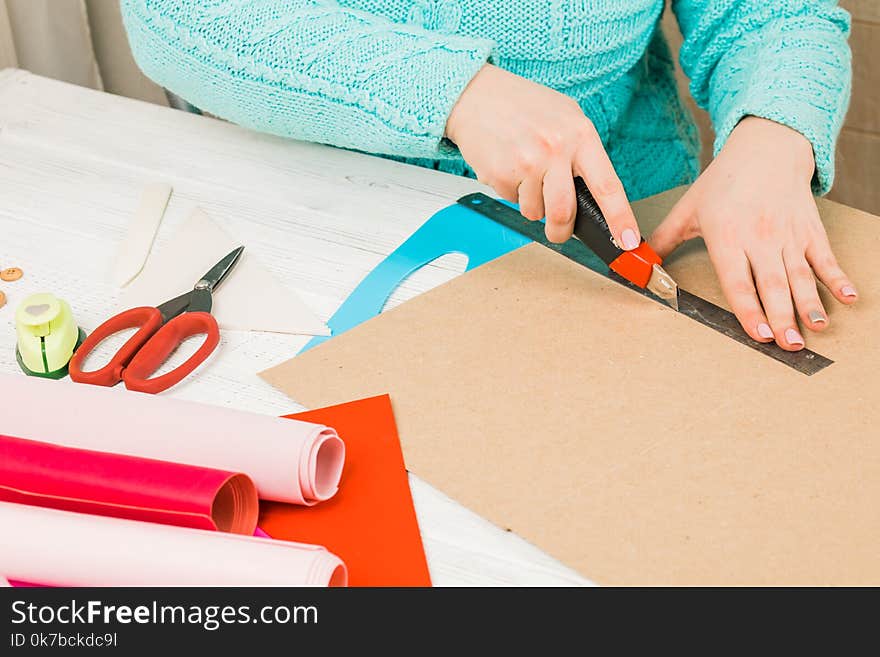 Handmade, the girl cuts out of paper. scrapbooking for a wedding