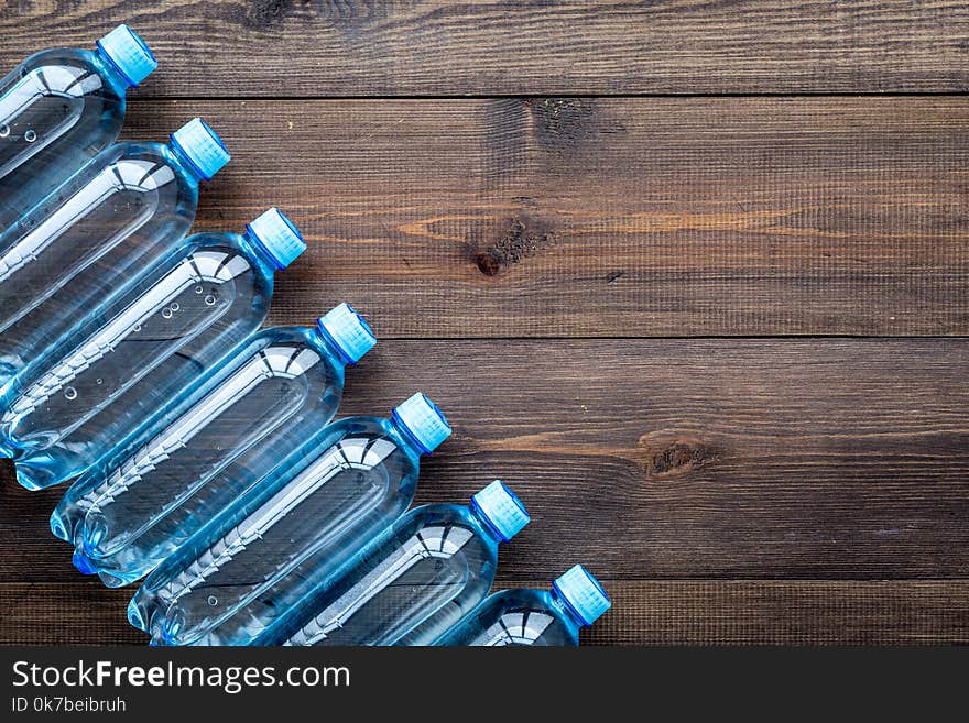 Drinking Water In Bottles On Dark Wooden Background Top View Copy Space