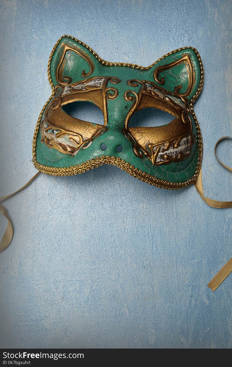 Beautiful carnival mask with ribbons for face on a blue background. Beautiful carnival mask with ribbons for face on a blue background