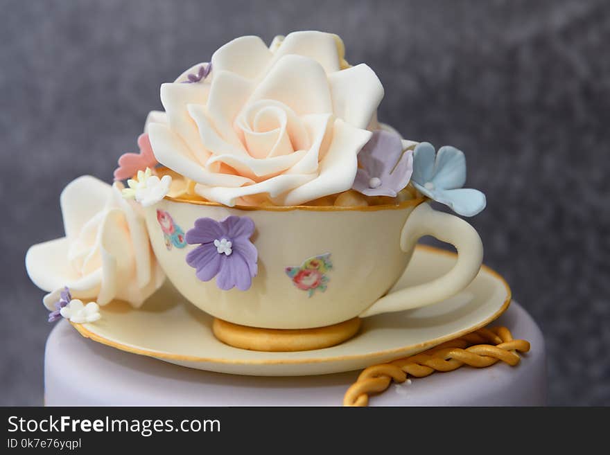 Home made Celebration cake with cup and saucer and sugar flowers
