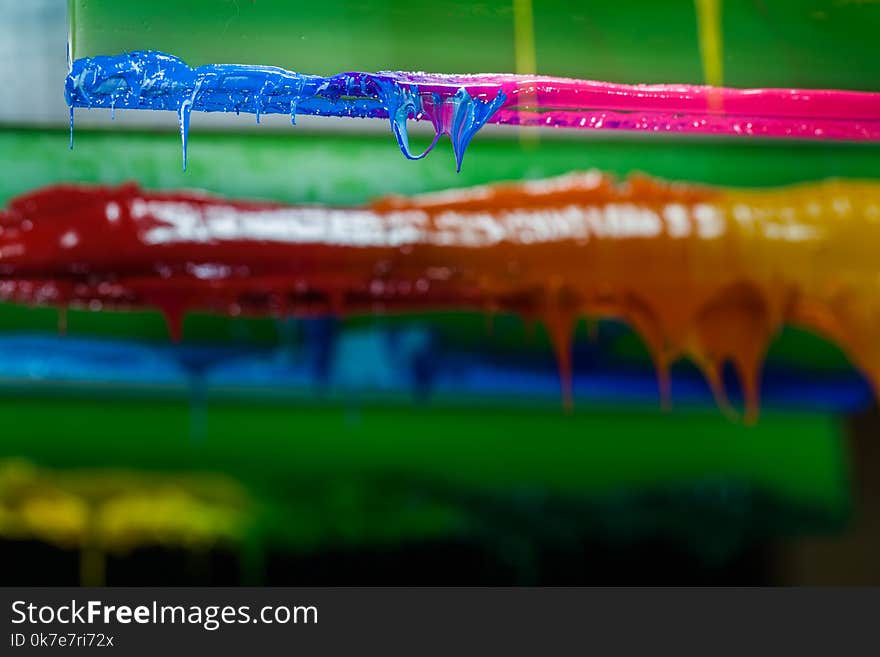 colors dripping from the rubber print handle