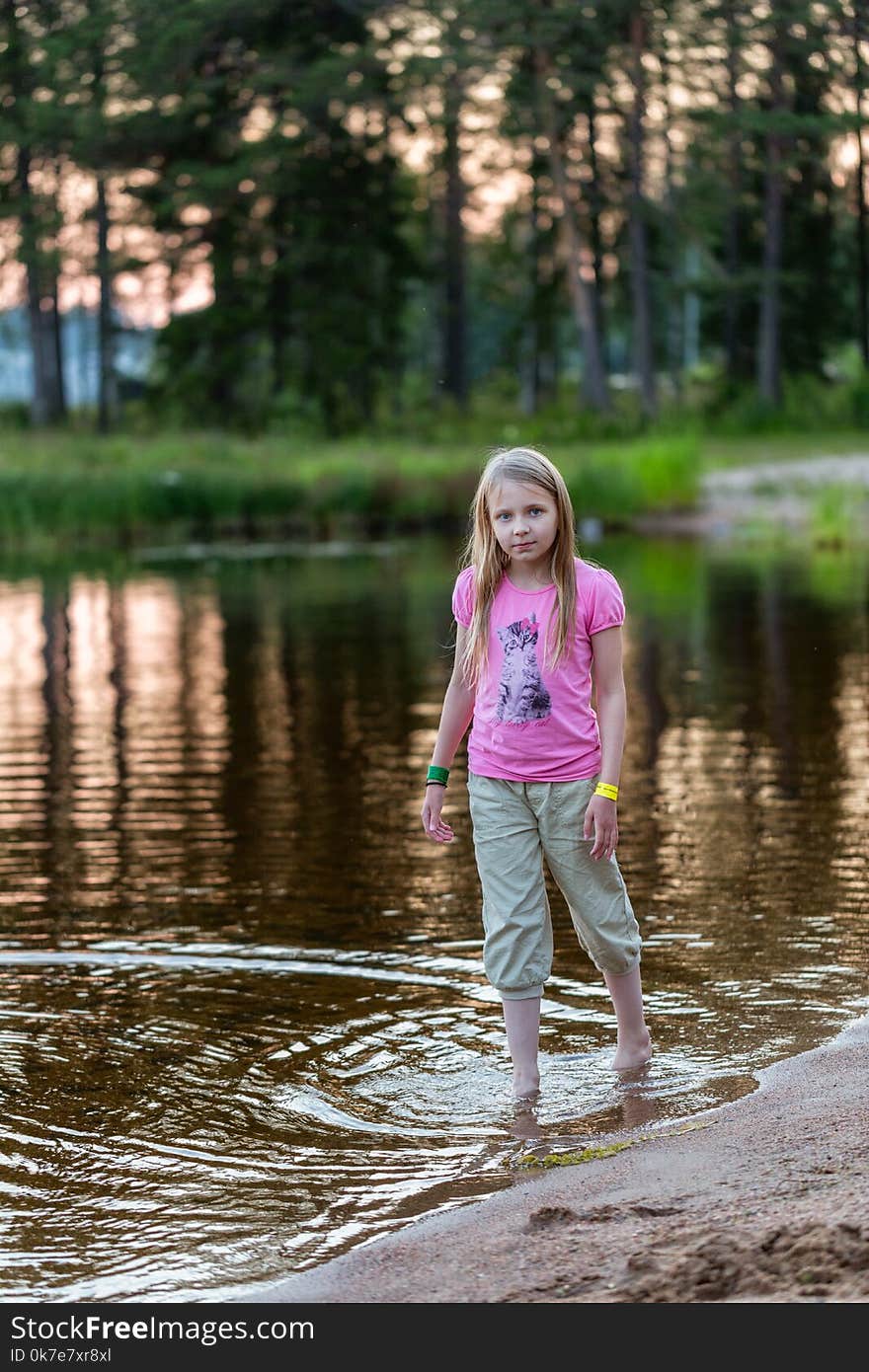 Young girl in the evening on the lake, Finland