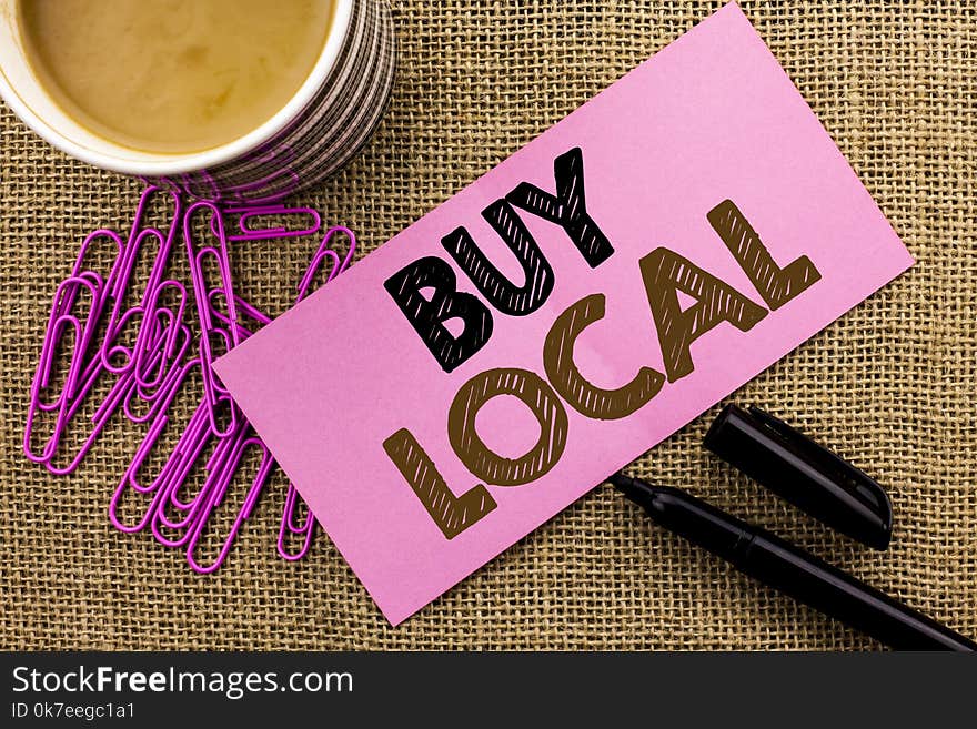 Handwriting text writing Buy Local. Concept meaning Buying Purchase Locally Shop Store Market Buylocal Retailers written Pink Sticky Note Paper the jute background Coffee Cup Pen Pins. Handwriting text writing Buy Local. Concept meaning Buying Purchase Locally Shop Store Market Buylocal Retailers written Pink Sticky Note Paper the jute background Coffee Cup Pen Pins.