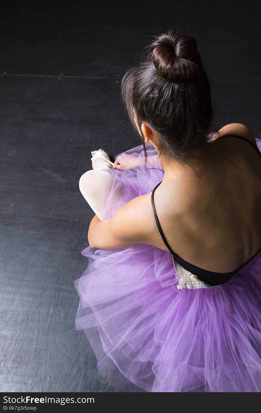 Dancer in purple tutu preparing for performance. Dancer in purple tutu preparing for performance