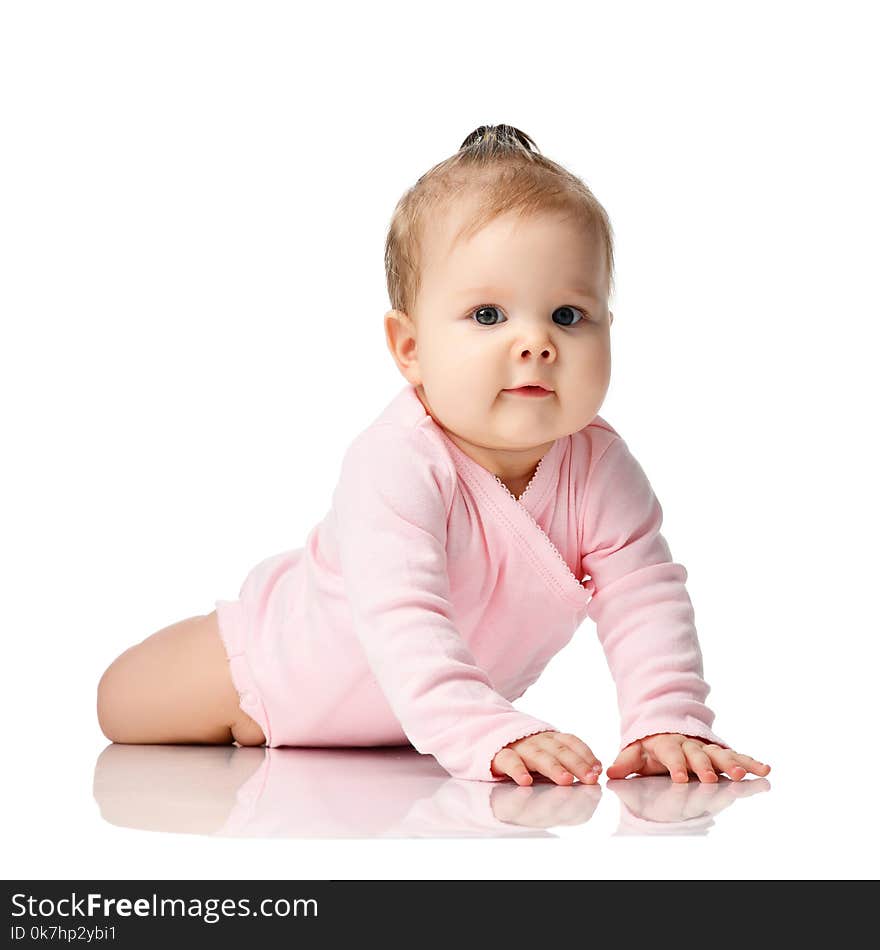 8 month infant child baby girl toddler lying in pink shirt isolated on a white background. 8 month infant child baby girl toddler lying in pink shirt isolated on a white background