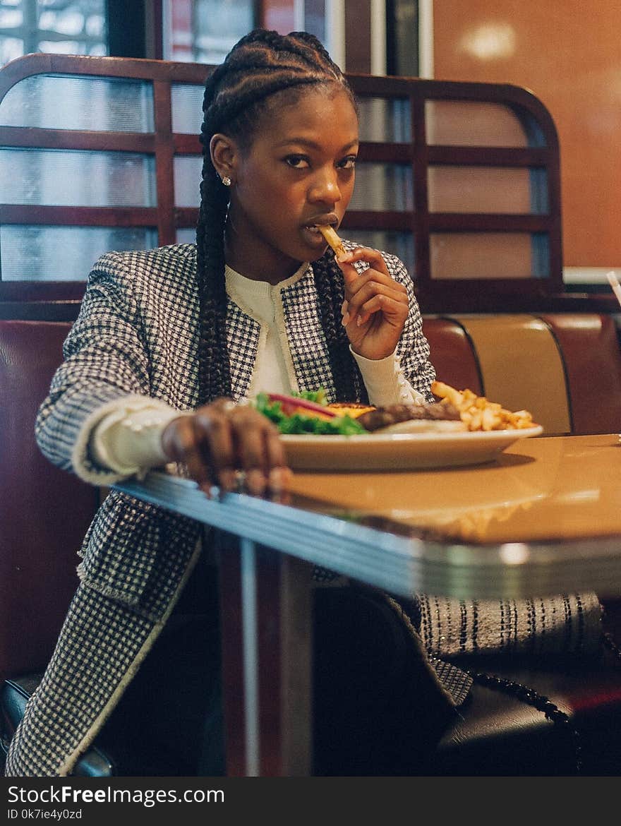 Photo of a Woman Eating at the Restaurant