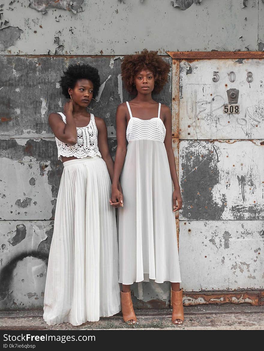 Photo of Women in White Sleeveless Dresses