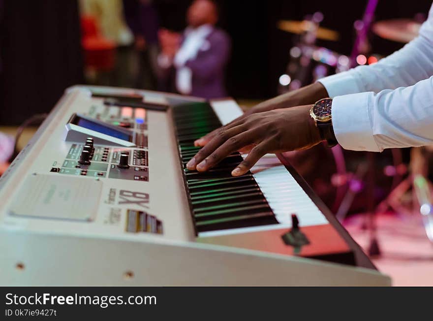 Photo of a Person Playing Electronic Keyboard