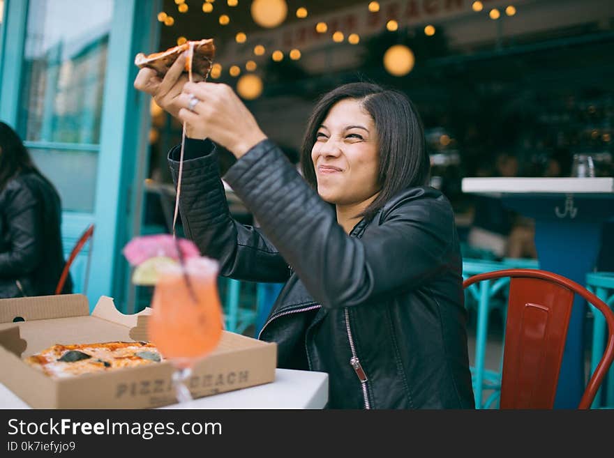 Photo of Woman Holding Pizza