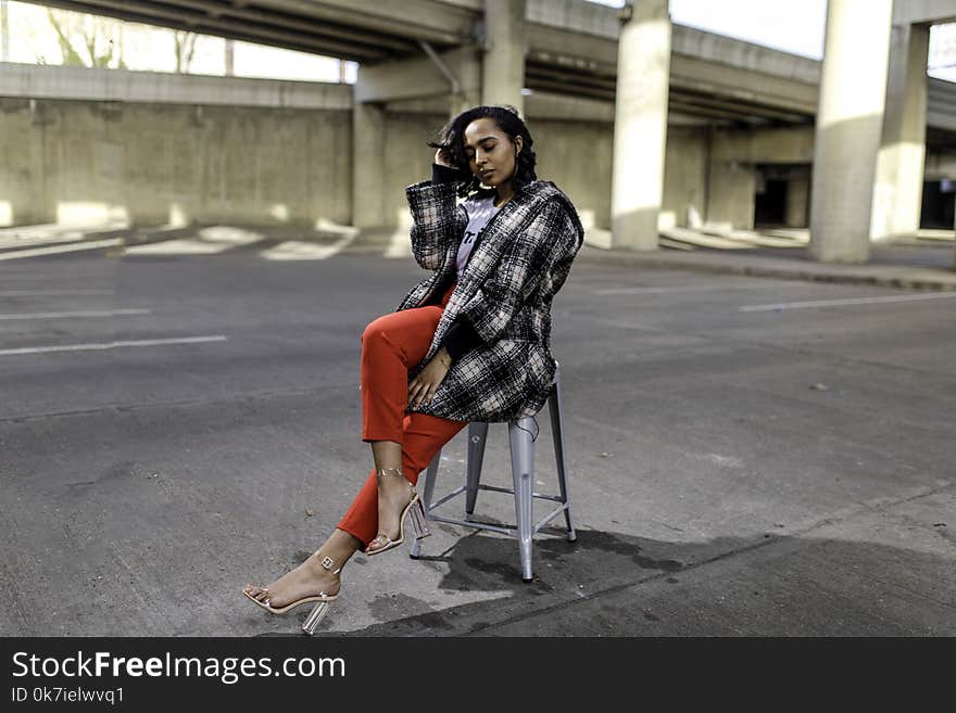 Photo of Woman Sitting in the Middle of the Road