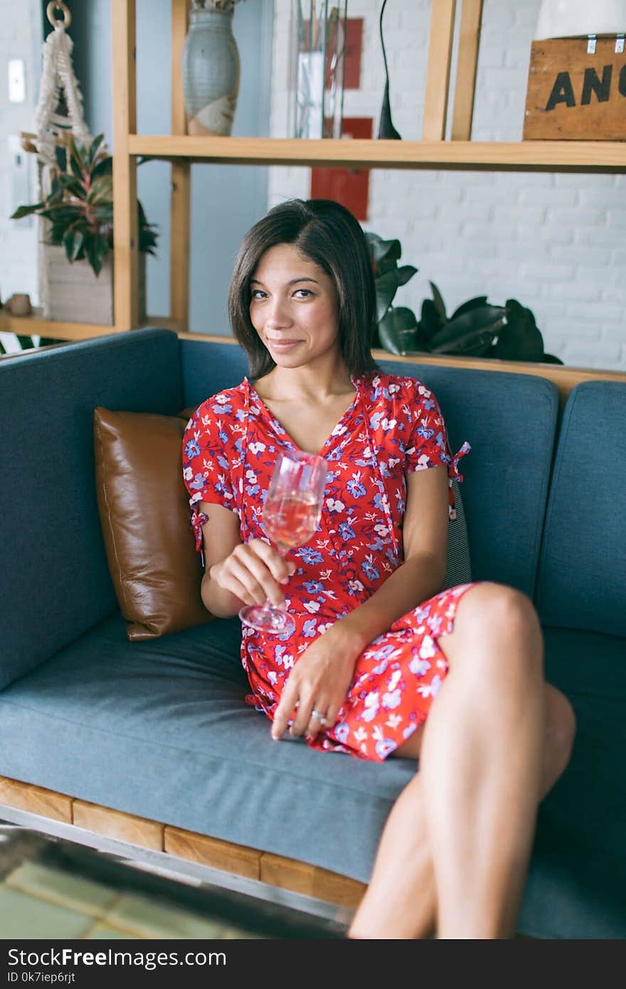 Woman Sitting on Sofa Holding Wine Glass