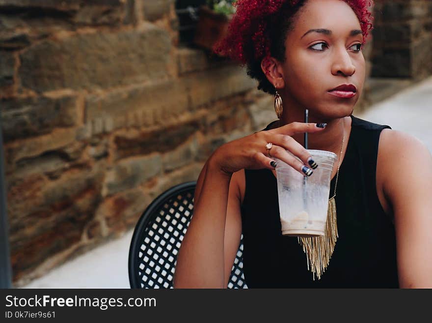 Woman in Black Sleeveless Top Holding Clear Plastic Disposable Cup