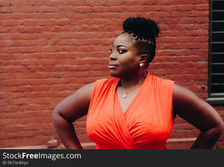 Woman Wearing Orange Sleeveless Top