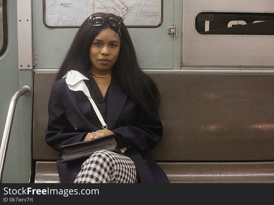 Woman Sitting on Gray Metal Bench