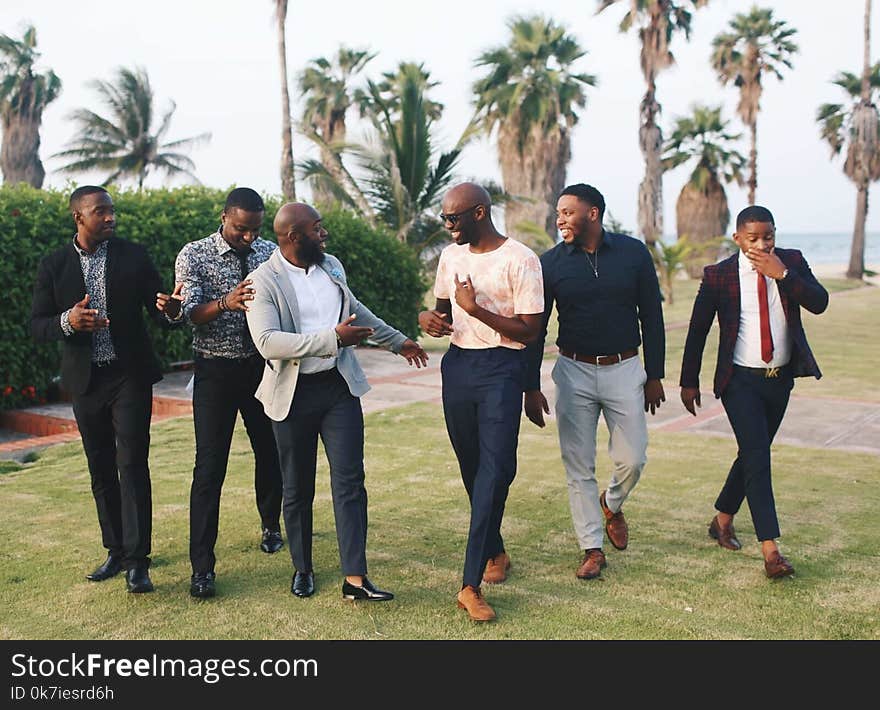 Six Men Standing While Laughing