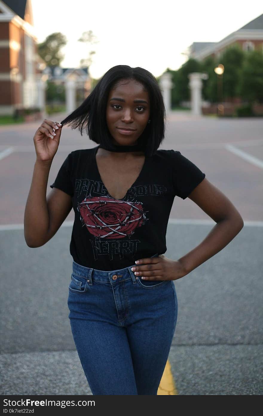 Woman in Black Top and Blue Jeans