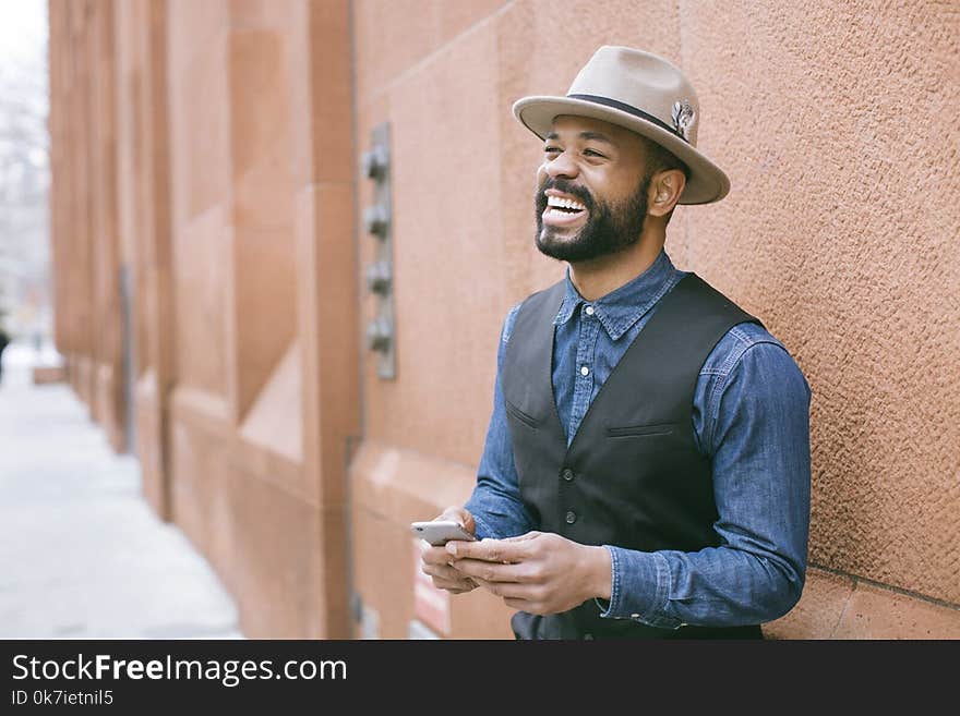 Man Wearing Black Vest and Blue Denim Shirt