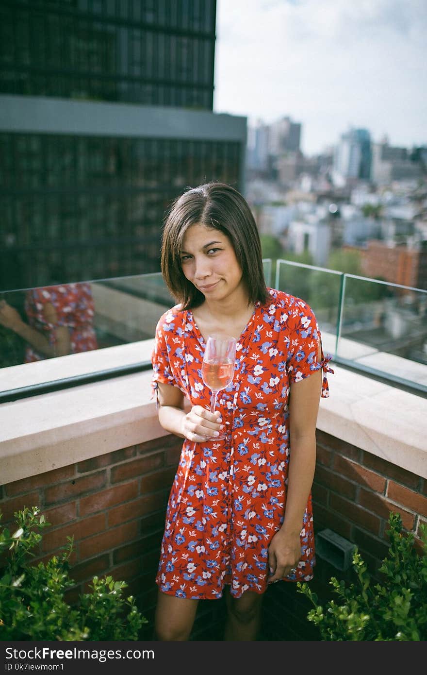 Woman Wearing Floral Dress Holding Wine Glass