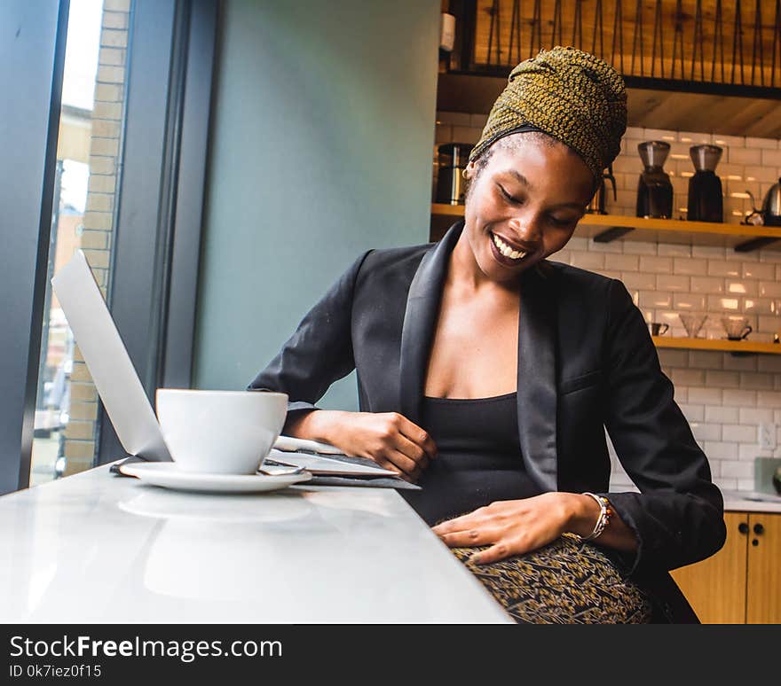 Woman in Black Blazer with a big smile on her face