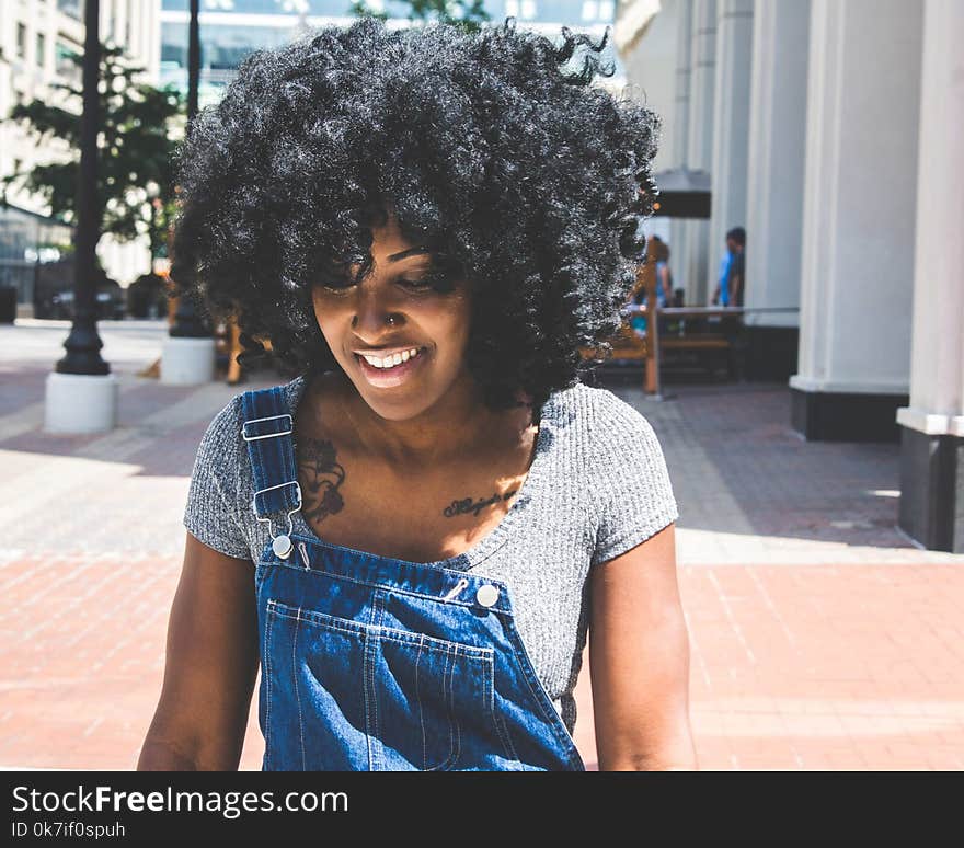 Woman in Gray Scoop-neck Shirt and Blue Denim Overalls