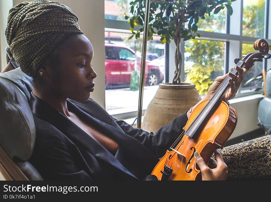 Woman Holding Violin by the Window