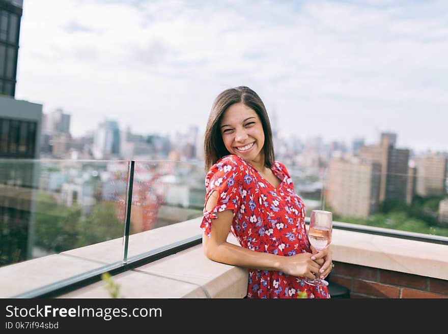 Woman Wearing a Floral Dress with the a Rooftop View