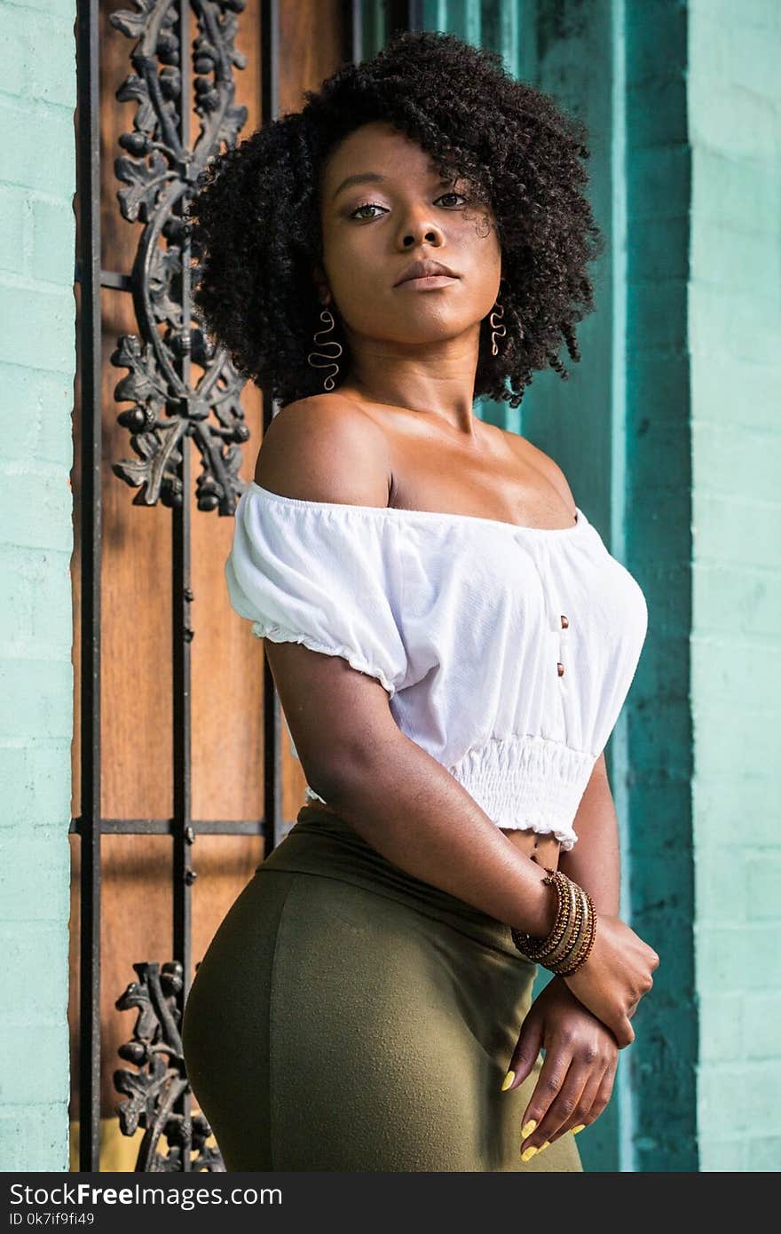 Woman Wearing White Off-shoulder Shirt and Green Bottoms