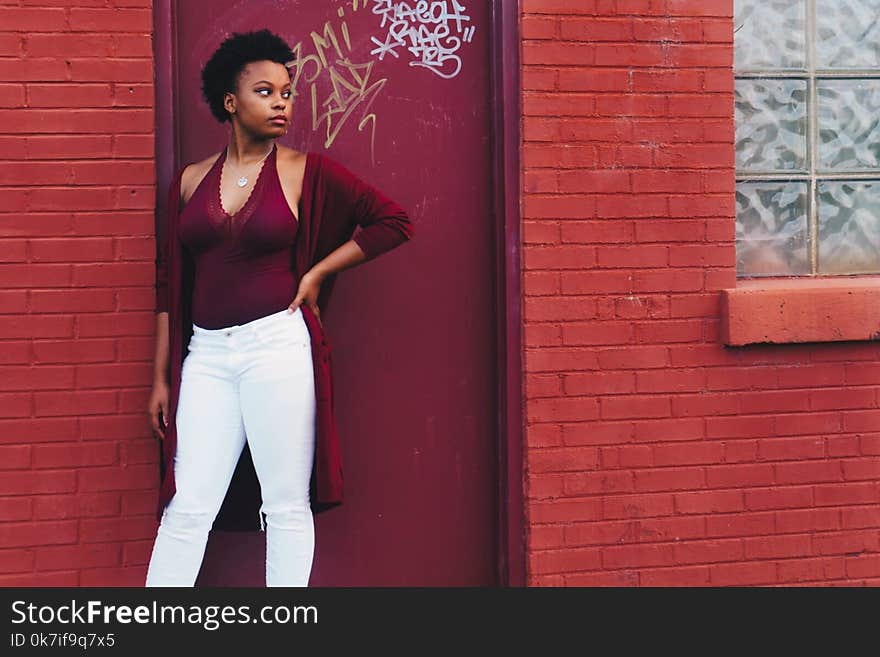 Woman in Red Halter Top and White Pants