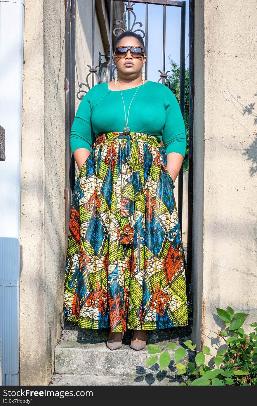 Woman Wearing Green Long-sleeved Shirt and Printed Skirt