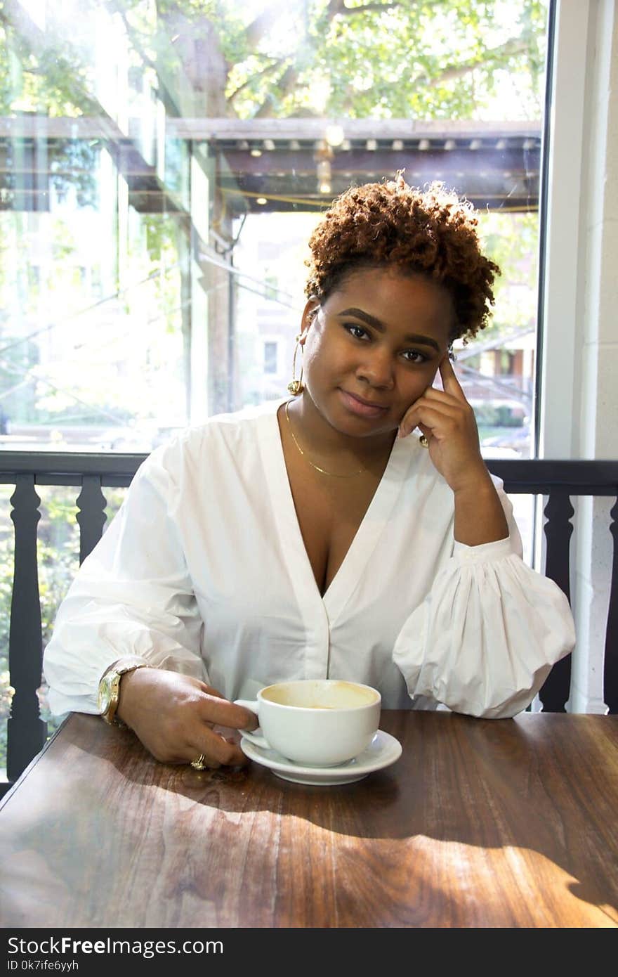 Woman Wearing White Deep V-neck Long-sleeved Blouse Holding White Ceramic Teacup