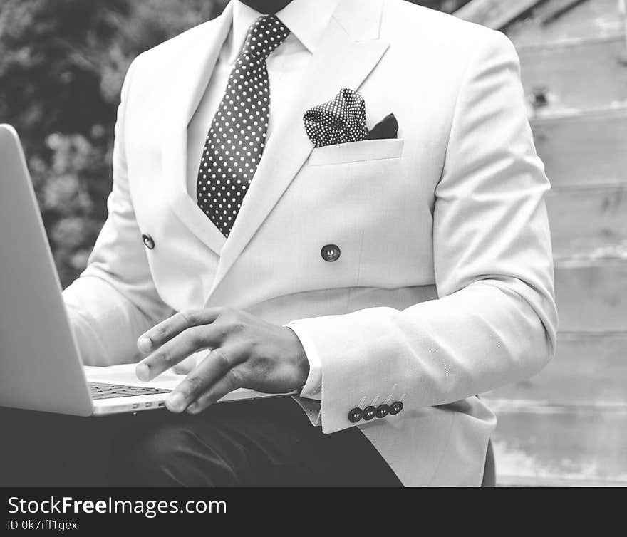 Grayscale Photo of Man Wearing White Suit Jacket