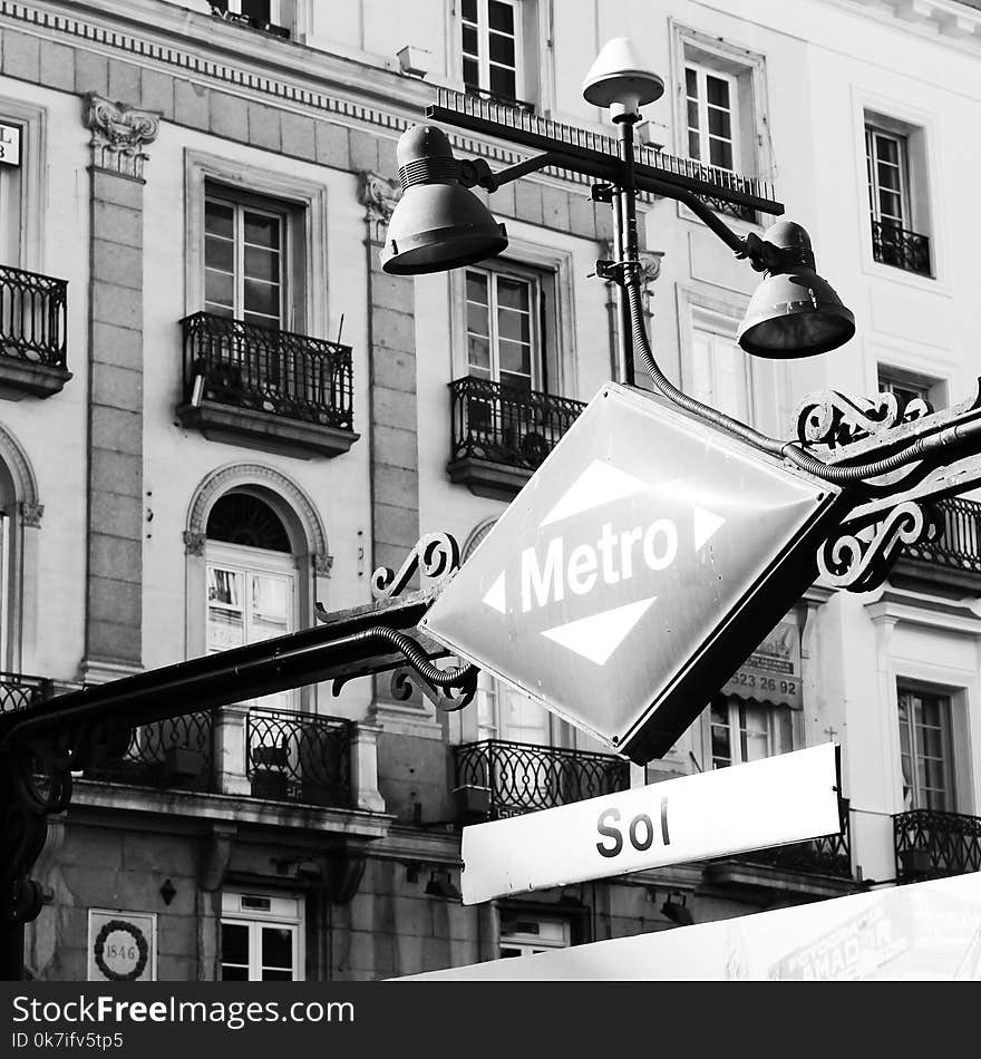 Grayscale Photography of Patio Light and Sign