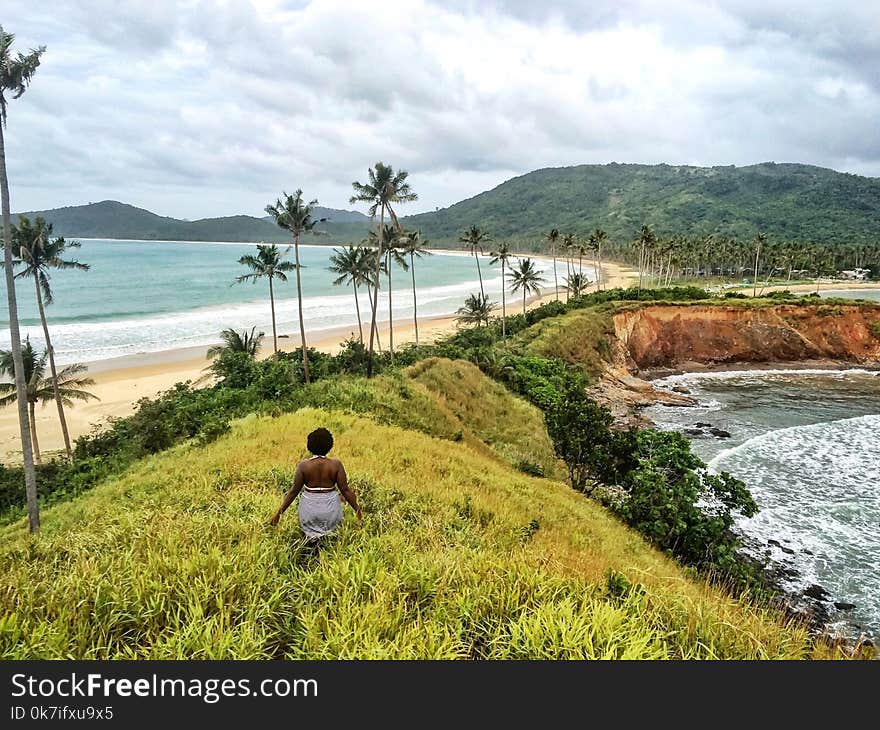 Woman Standing on Hill Near the Sea Graphic Wallpaper