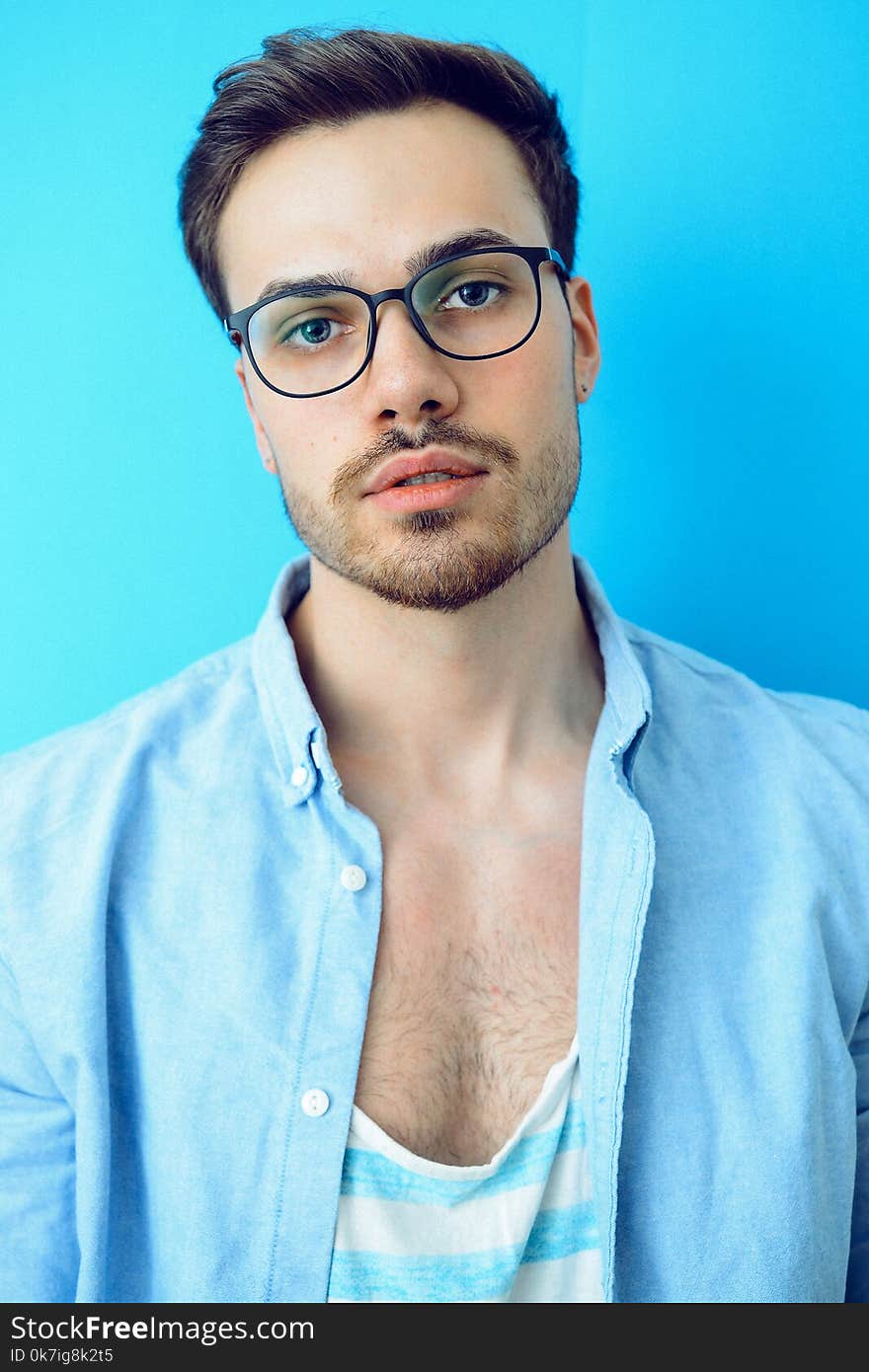 Man in Black Framed Eyeglasses and Blue Button-up Shirt