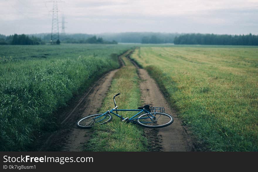 Landscape Photography of Blue Commuter Bike on Green Grass