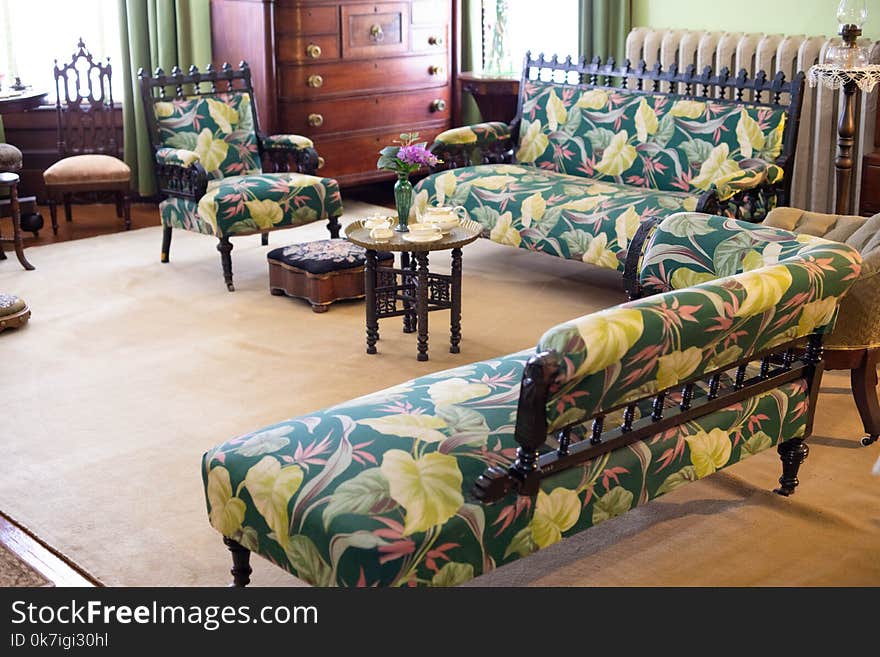 Living room from an old antique house with antique wooden furnitures such as table and sofa chairs wrapped with cloth