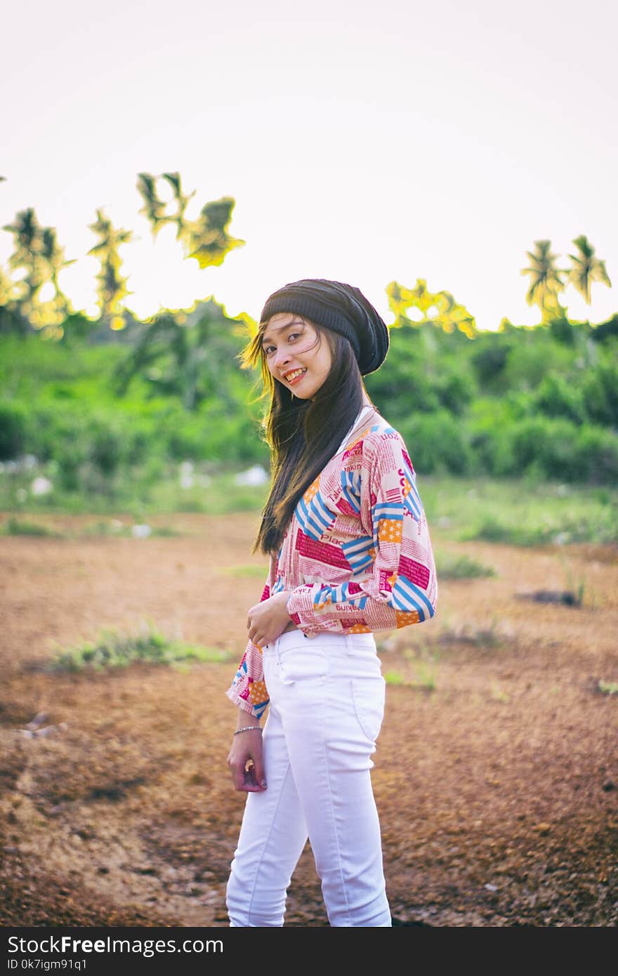 Woman Wearing Black Beanie Standing on Brown Soil Field