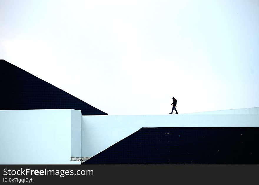 Man Walking on White Platform